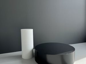 White cylinder and black podium on wheels